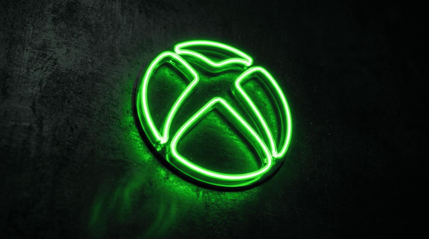 A glowing green neon console logo sign illuminating a dark textured wall in a professional studio setting.