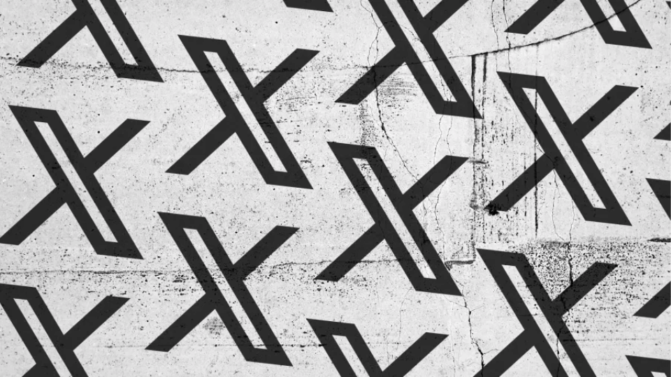 A close-up view of a textured gray concrete wall painted with a clean repeating pattern of black X logos.