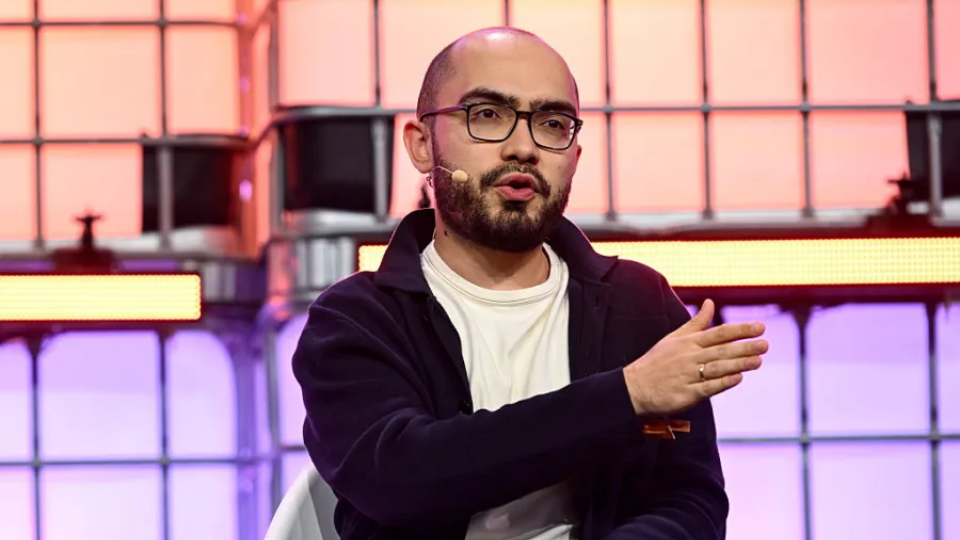 Alex Mashrabov speaking on stage during a tech conference panel.