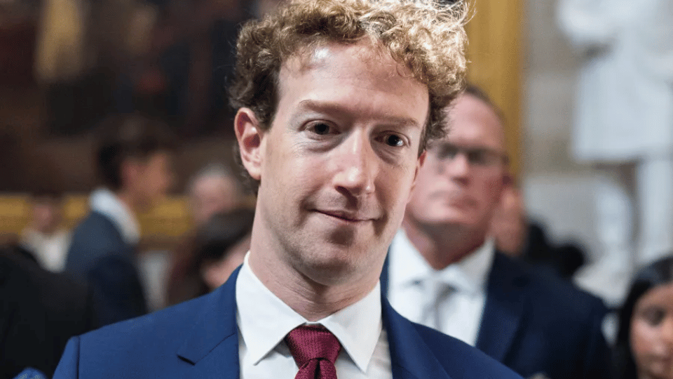 Mark Zuckerberg in a blue suit and red tie at a formal legal proceeding.