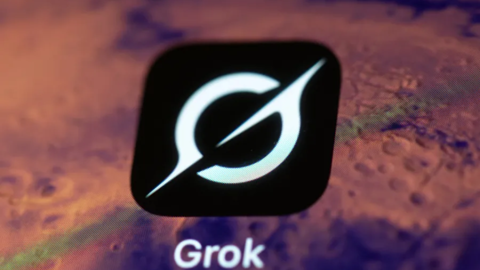 A smartphone screen displaying the white xAI Grok logo on a black surface.