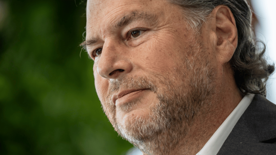 Salesforce CEO Marc Benioff standing outside and looking toward the side.
