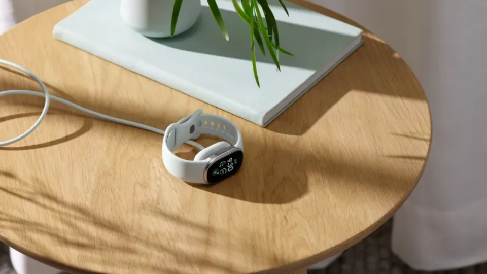 Three Fitbit Edge fitness trackers displayed side by side in different band colors.